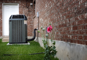 AC unit outside beside a brick house