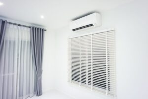 ductless AC system installed in a room, over a window.