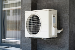 Ductless mini-split outdoor unit attached to the side of a house.