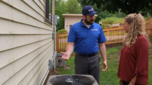 Technician explains AC issue to the homeowner.