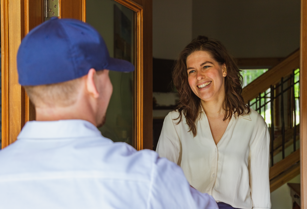 Lancaster electrician greets a homeowner at her front door