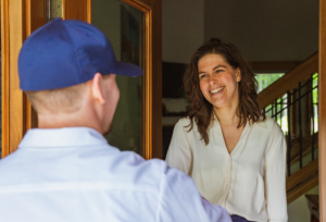 Lancaster electrician greets a homeowner at her front door.