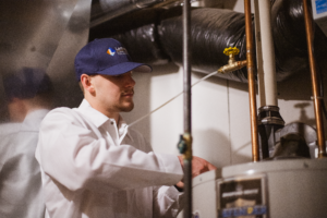 Lancaster plumber inspecting a water heater.