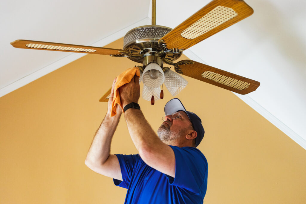 Electrician installing ceiling fan lights