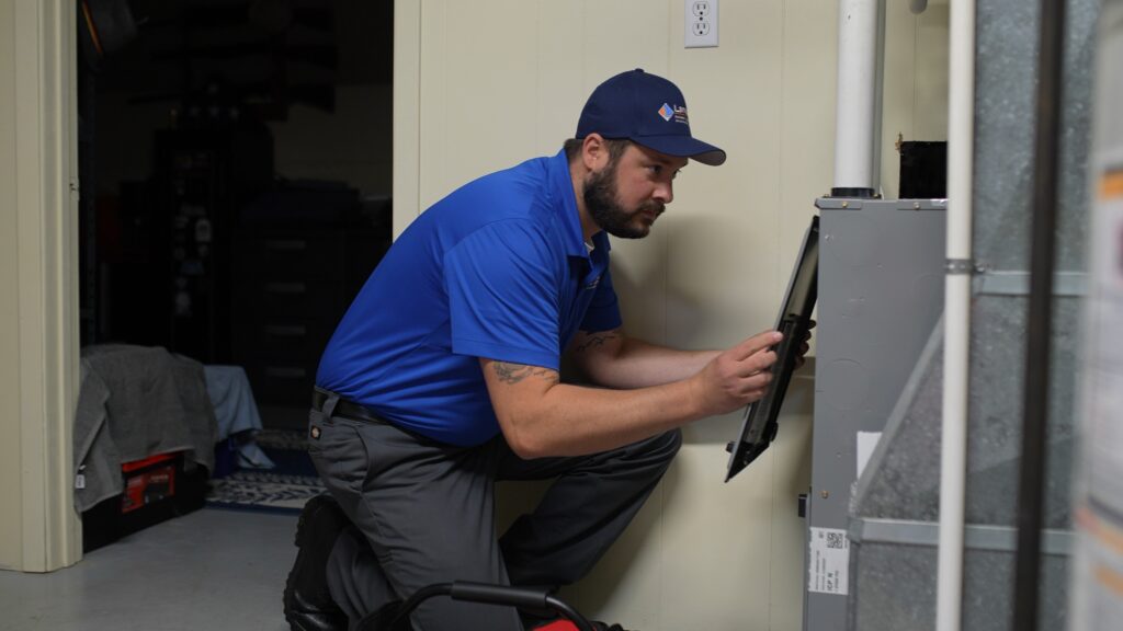 HVAC technician removes the filter from a furnace