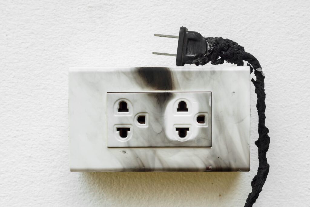 An electrical plug and outlet burnt